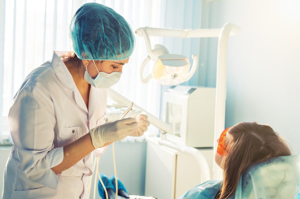 A young female dentist and a patient